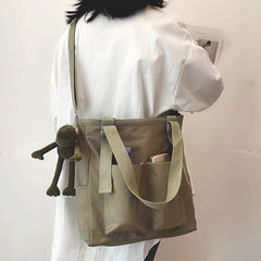 Adistore women's shopper bag with zippered main compartment, crossbody strap, and tote shoulder handle in solid design.