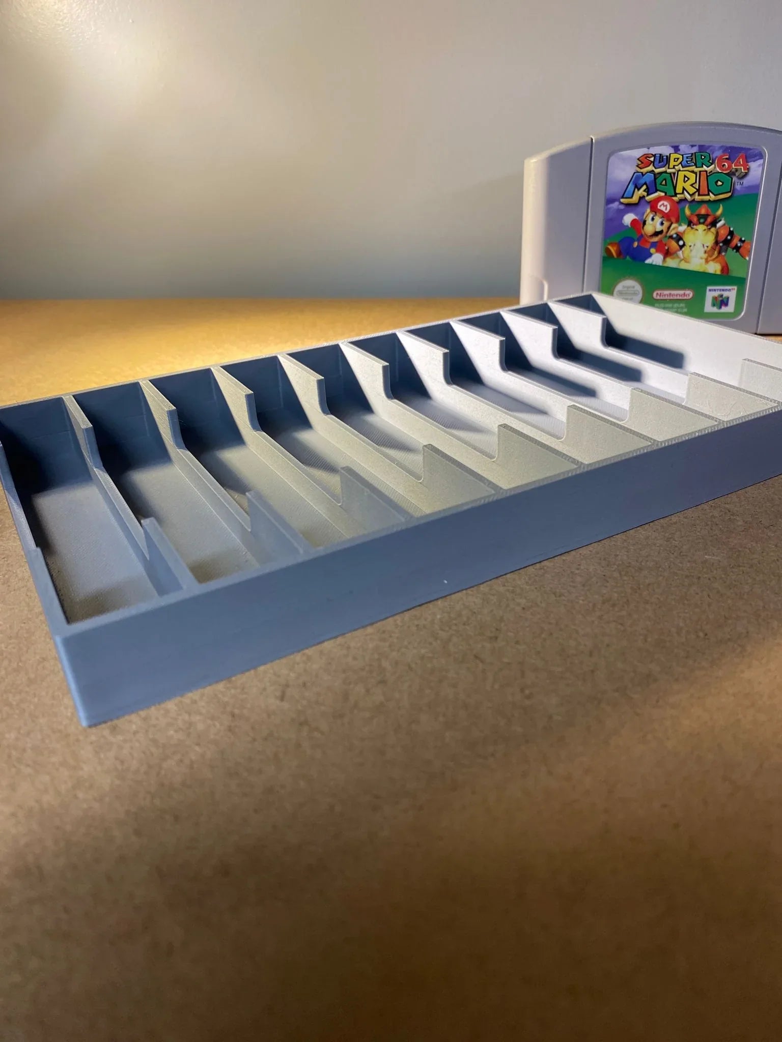Game Display N64 game storage case holding 12 Nintendo 64 cartridges, organized and protected for gaming collection.