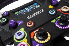 Trak Racer UK Conspit 310 APEX steering wheel and base, black racing wheel with textured grip and adjustable controls.