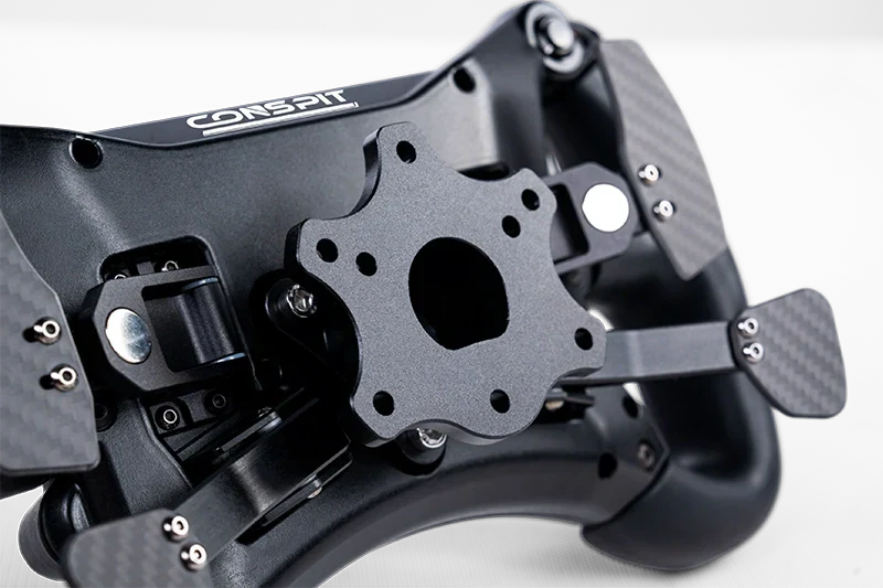 Conspit 300GT racing steering wheel by Trak Racer UK mounted on a steering wheel base for sim racing setups.