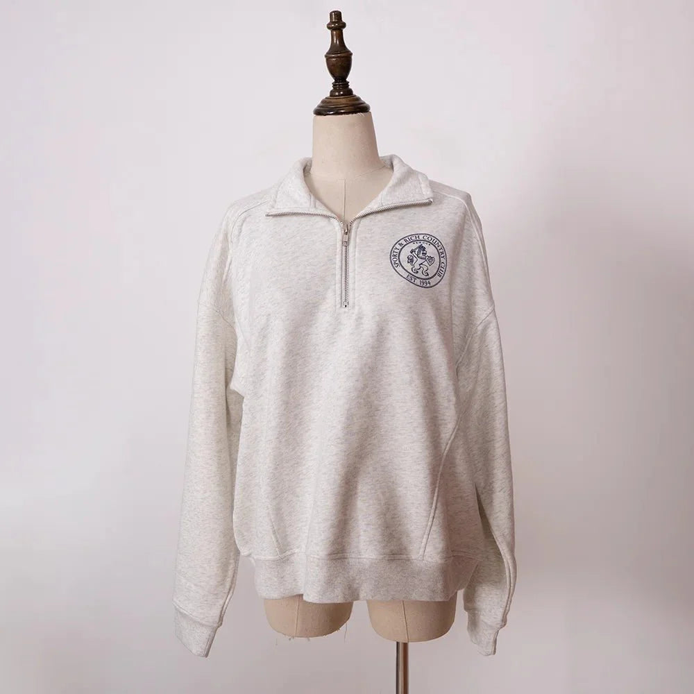 Women’s ZESSAM Club graphic sweatshirt by Adistore with long sleeves and collar, featuring a stylish design and comfortable fit.
