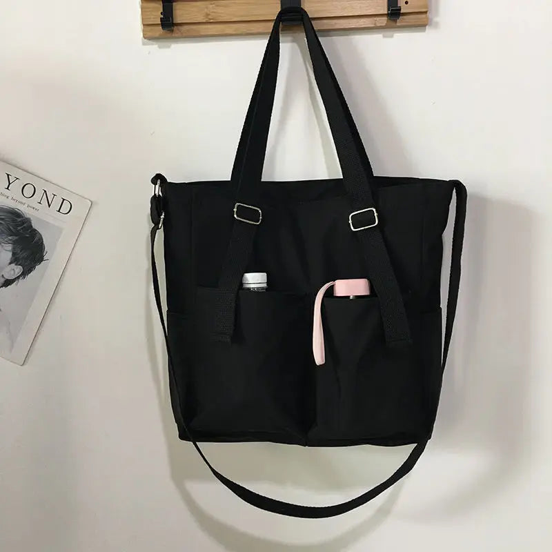 Adistore women's shopper bag with zippered closure, featuring a solid design and versatile crossbody and tote shoulder styles.