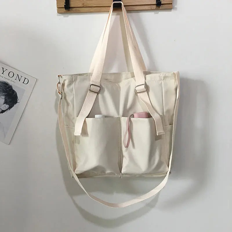 Adistore women's shopper bag with zippered closure, featuring a solid design, crossbody strap, and shoulder tote style.