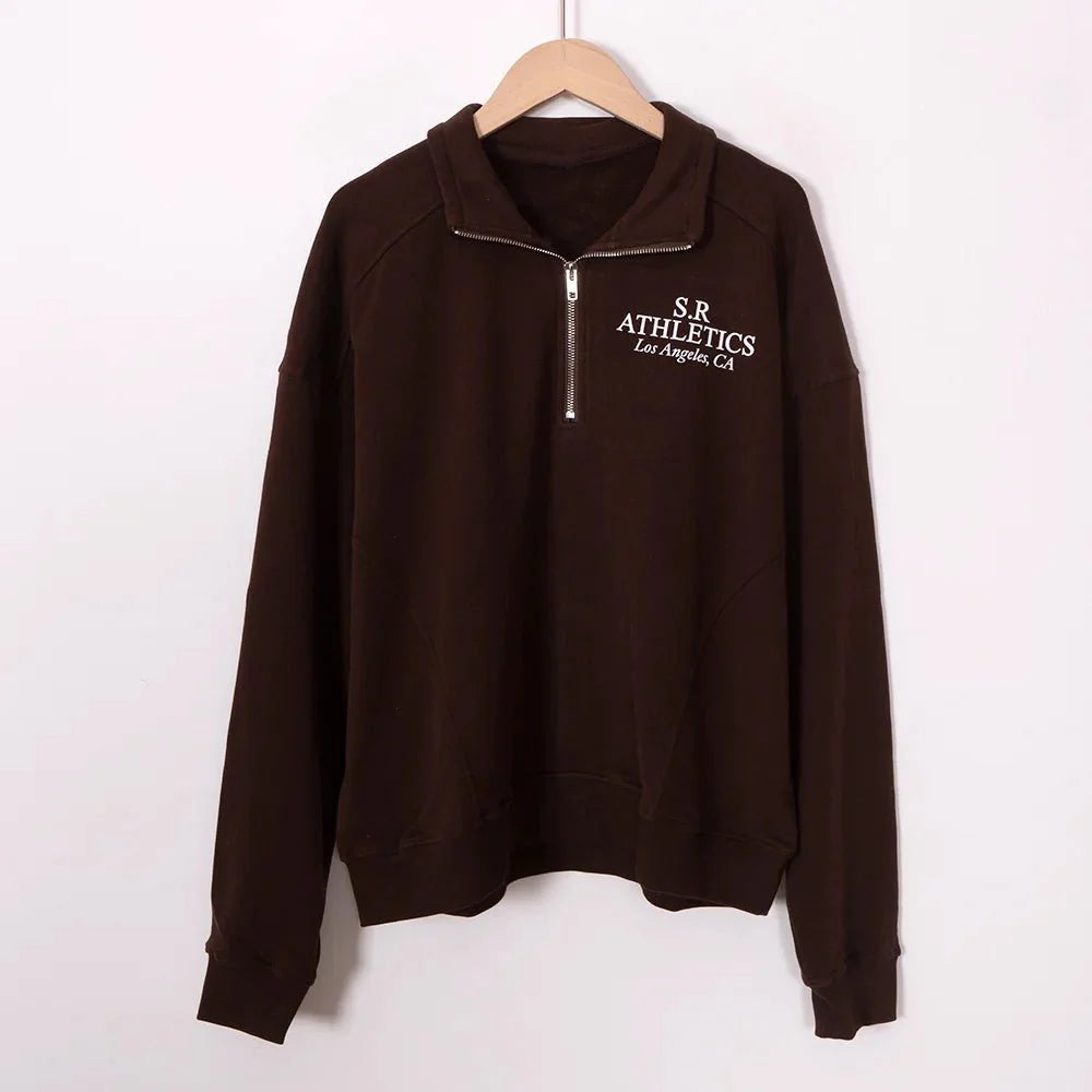 Women’s ZESSAM Club Graphic Sweatshirt by Adistore featuring long sleeves and a collar, displayed on a mannequin.