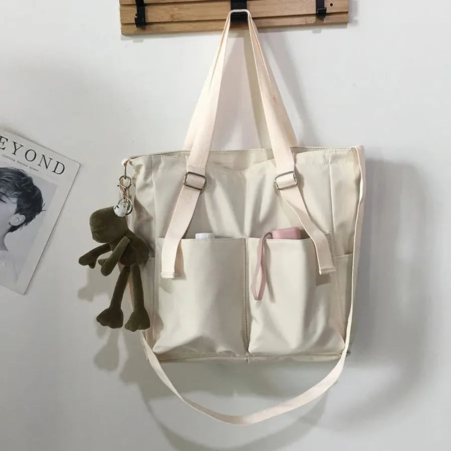 Adistore women’s shopper bag with zipper, featuring solid design, crossbody and tote shoulder styles, made of durable material.