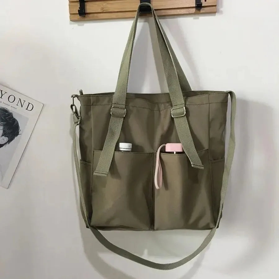 Women’s Adistore shopper bag with zippered solid design, versatile crossbody and tote shoulder bag in durable material.
