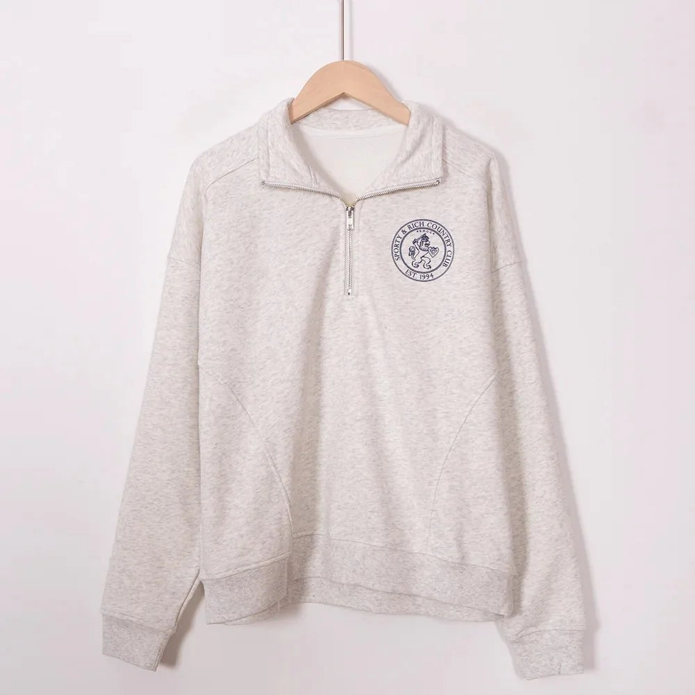 Women’s ZESSAM Club graphic sweatshirt by Adistore with long sleeves and a collar, featuring a stylish, casual design.