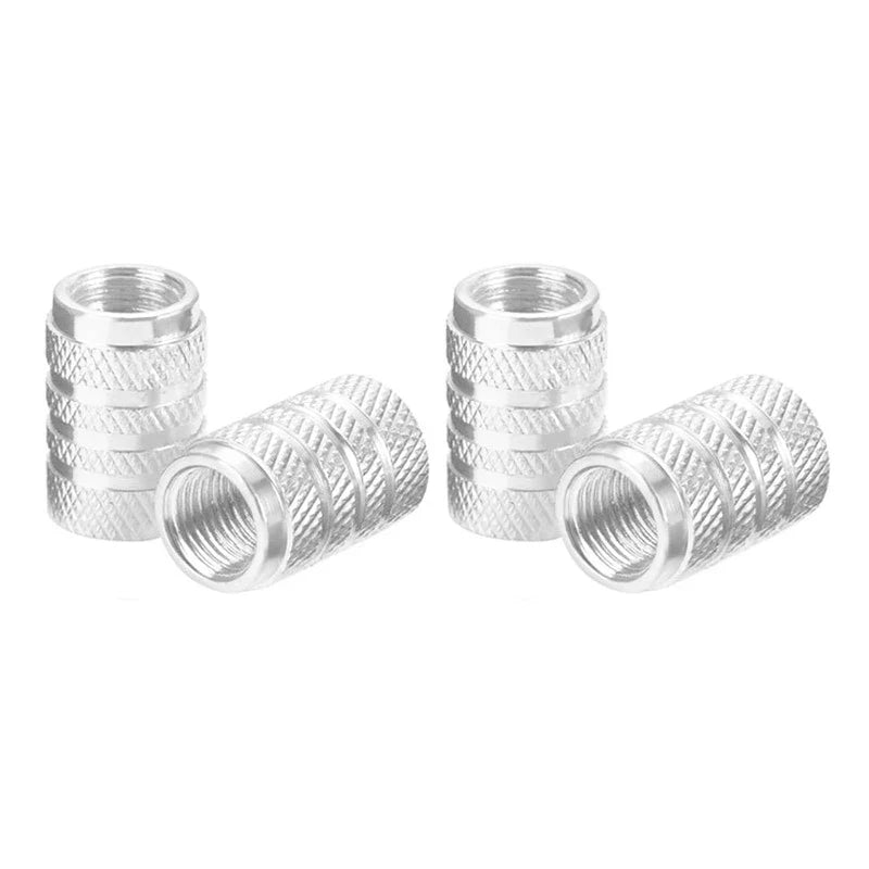 Set of four Eliteridegear aluminum car wheel tire valve stem caps with dust covers on a vehicle wheel.