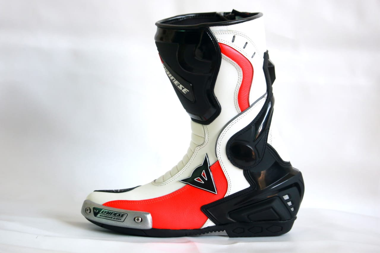 Damotogear Laguna Seca 4 leather racing suit in white, black, and red with protective padding and detailed stitching.