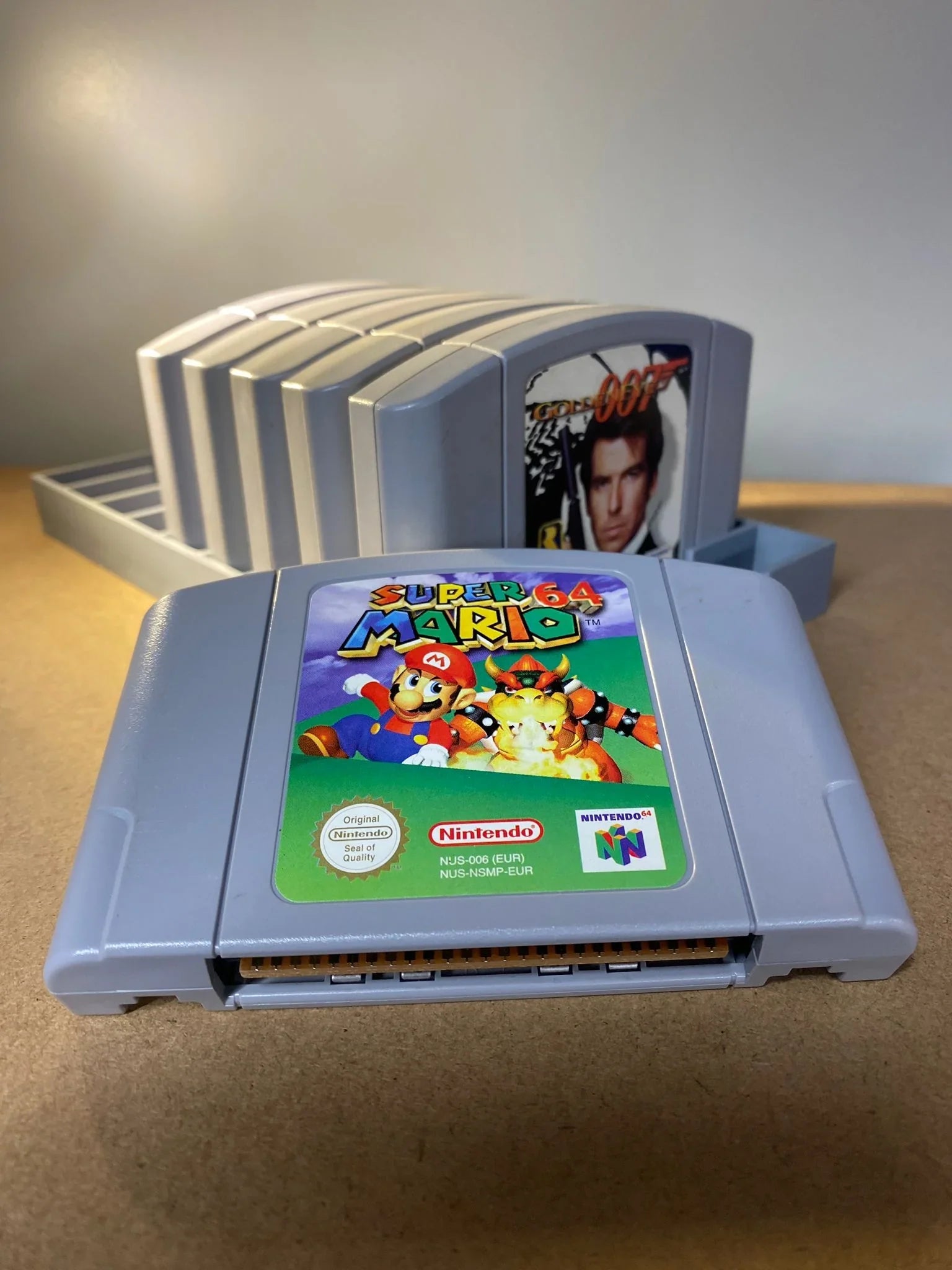 Game Display N64 game storage case holding 12 Nintendo 64 cartridges, organized and ready for display or collection.