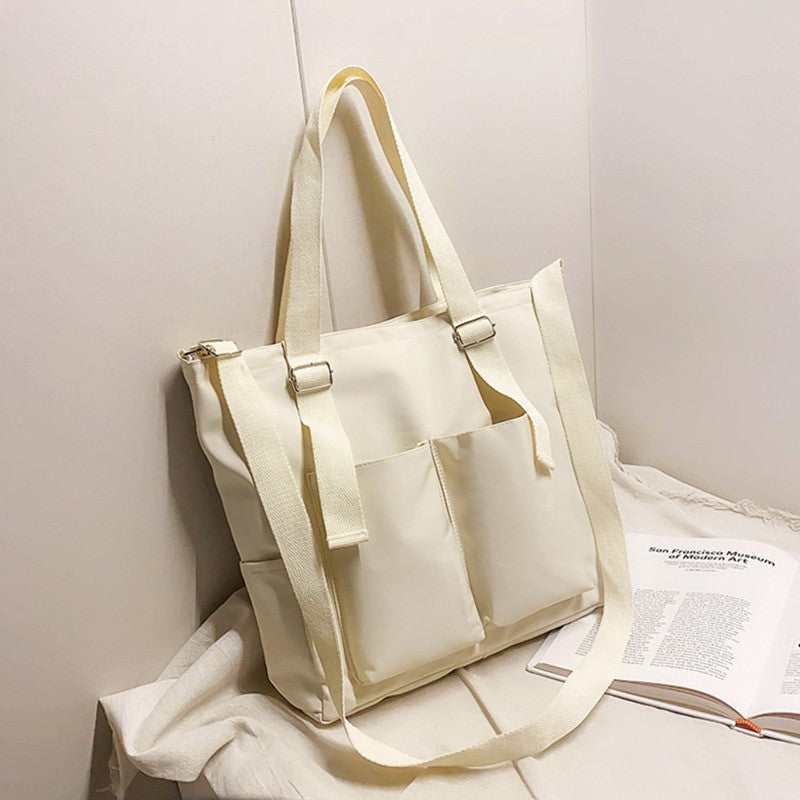 Adistore women's shopper bag with zippered closure, featuring a solid crossbody and tote shoulder bag design in durable material.