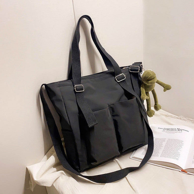 Women’s Adistore shopper bag with zippered closure, featuring a solid color design, crossbody and tote shoulder bag style.