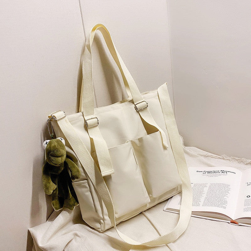 Adistore women's shopper bag with zippered solid design, featuring a crossbody and tote shoulder bag with spacious compartments.