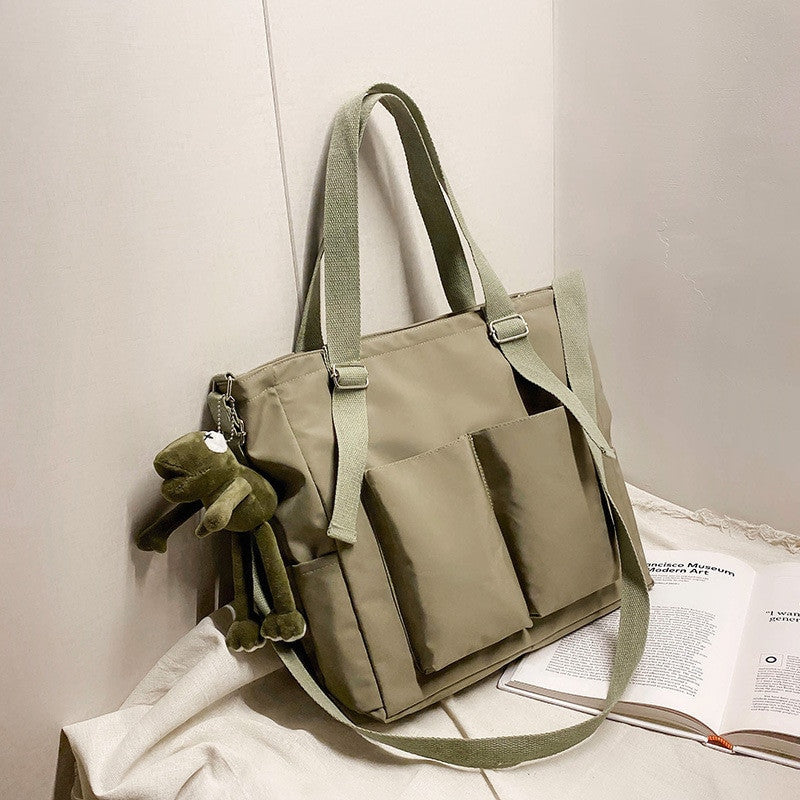 Adistore women's shopper bag with zippered solid design, versatile crossbody and tote shoulder bag style, fabric material.