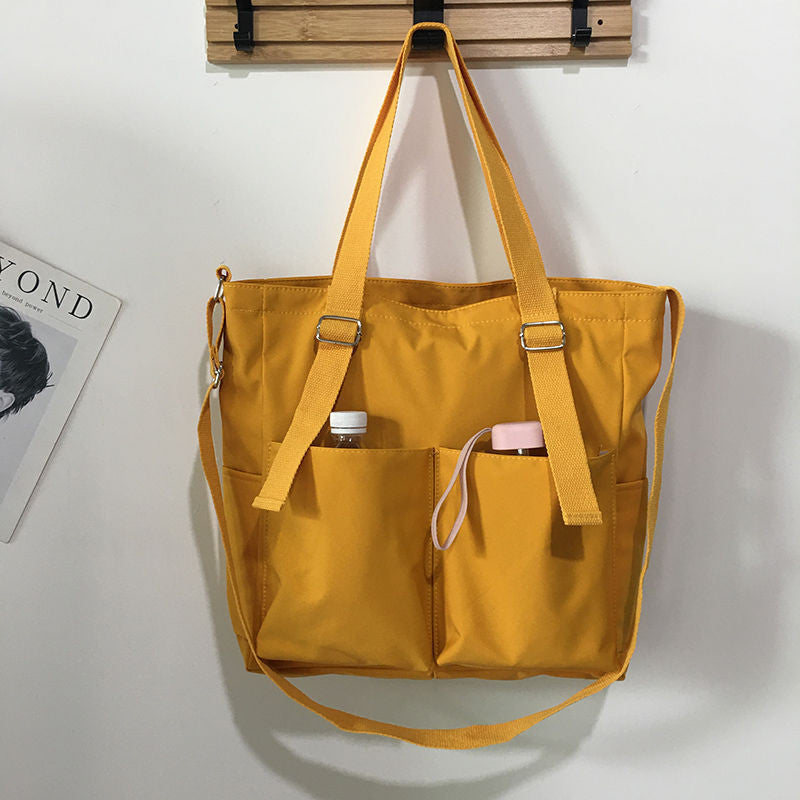 Adistore women's shopper bag with zippered compartments, versatile crossbody and tote shoulder bag in solid design.