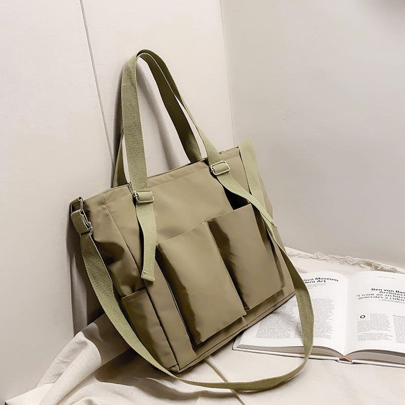 Women’s shopper bag by Adistore featuring a zippered solid design, versatile crossbody and tote shoulder bag with spacious interior.