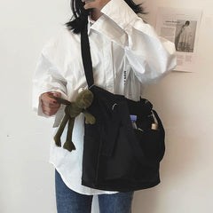 Adistore women's shopper bag with zippered solid design, featuring a crossbody and tote shoulder style, shown in black.
