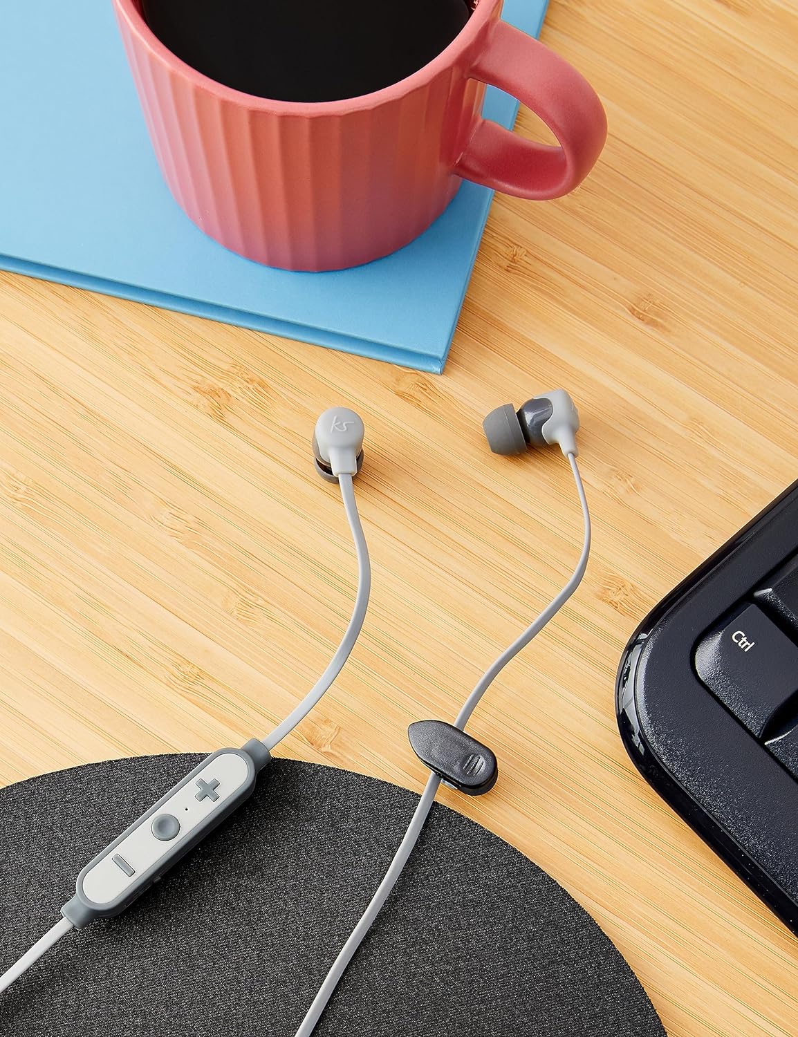 Kitsound Funk 15 in-ear wireless headphones with microphone in grey, showing the sleek design and earbud components.