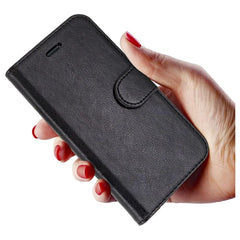 Black leather Moto G7 Play book flip case by Phone Base with magnetic closure, featuring a wallet-style design and card slots.