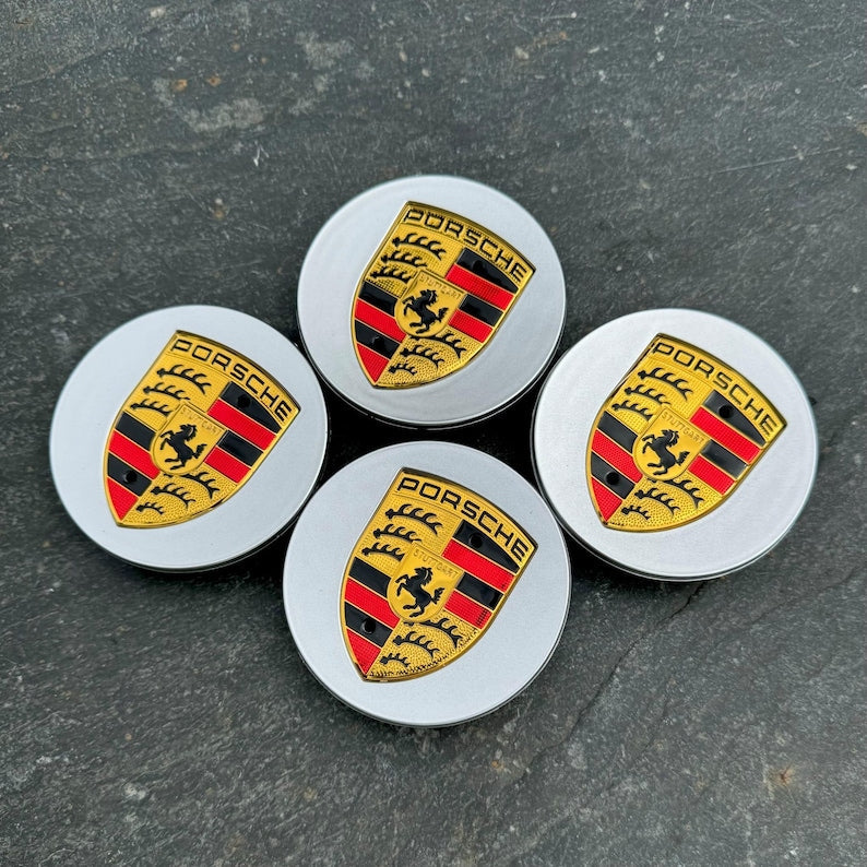 Set of four silver Porsche wheel centre caps by Eliteridegear, featuring sleek, round design with Porsche emblem detail.