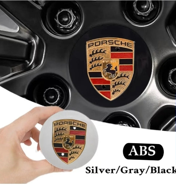 Black and gold Porsche wheel centre caps by Eliteridegear, showcasing sleek design and brand logo on a car wheel.