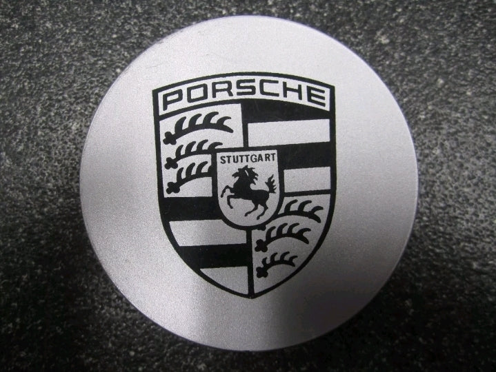 Set of four silver and black Porsche rim centre caps by Eliteridegear, showcasing sleek wheel centre detail.