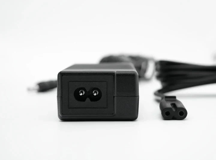Simagic P-APS accessories power supply unit for haptic, LED, and heel-stop modules in a racing simulator setup.